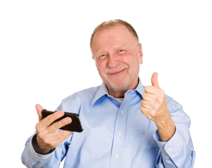 Closeup portrait, senior man, looking happy, excited at something on a cell phone, watching sports game match or reading an sms, e-mail, viewing latest news, isolated white background.